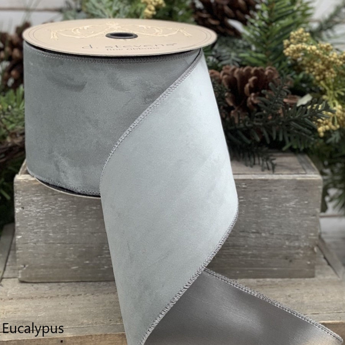 2.5-inch wide eucalyptus green velvet taffeta ribbon on a spool.
