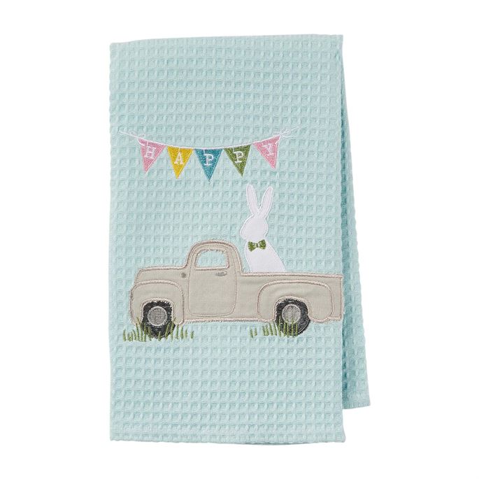 Light blue waffle weave towel with embroidered Easter bunny in a truck and a 'Happy' banner.