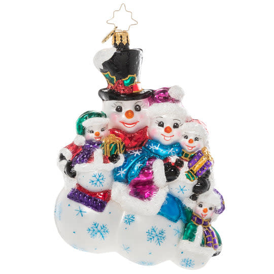 Three white snowman figurines with black eyes and carrot noses huddled together in a group hug.