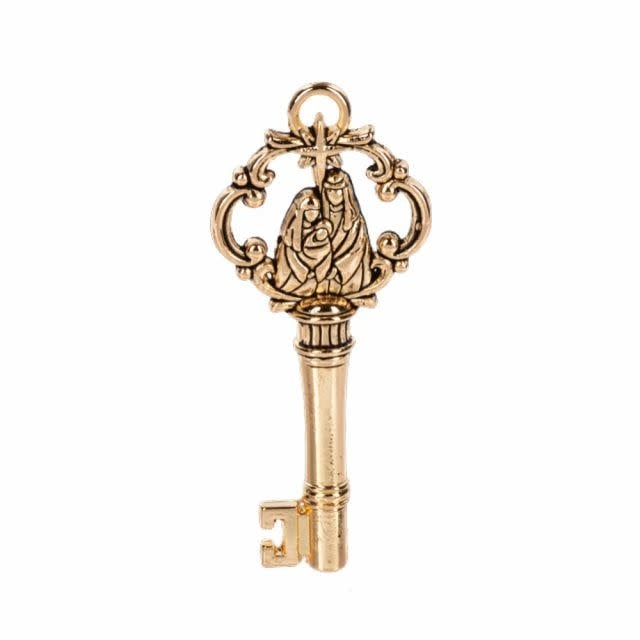 Gold-tone nativity scene key charm featuring a stable with Mary, Joseph, baby Jesus in a manger.