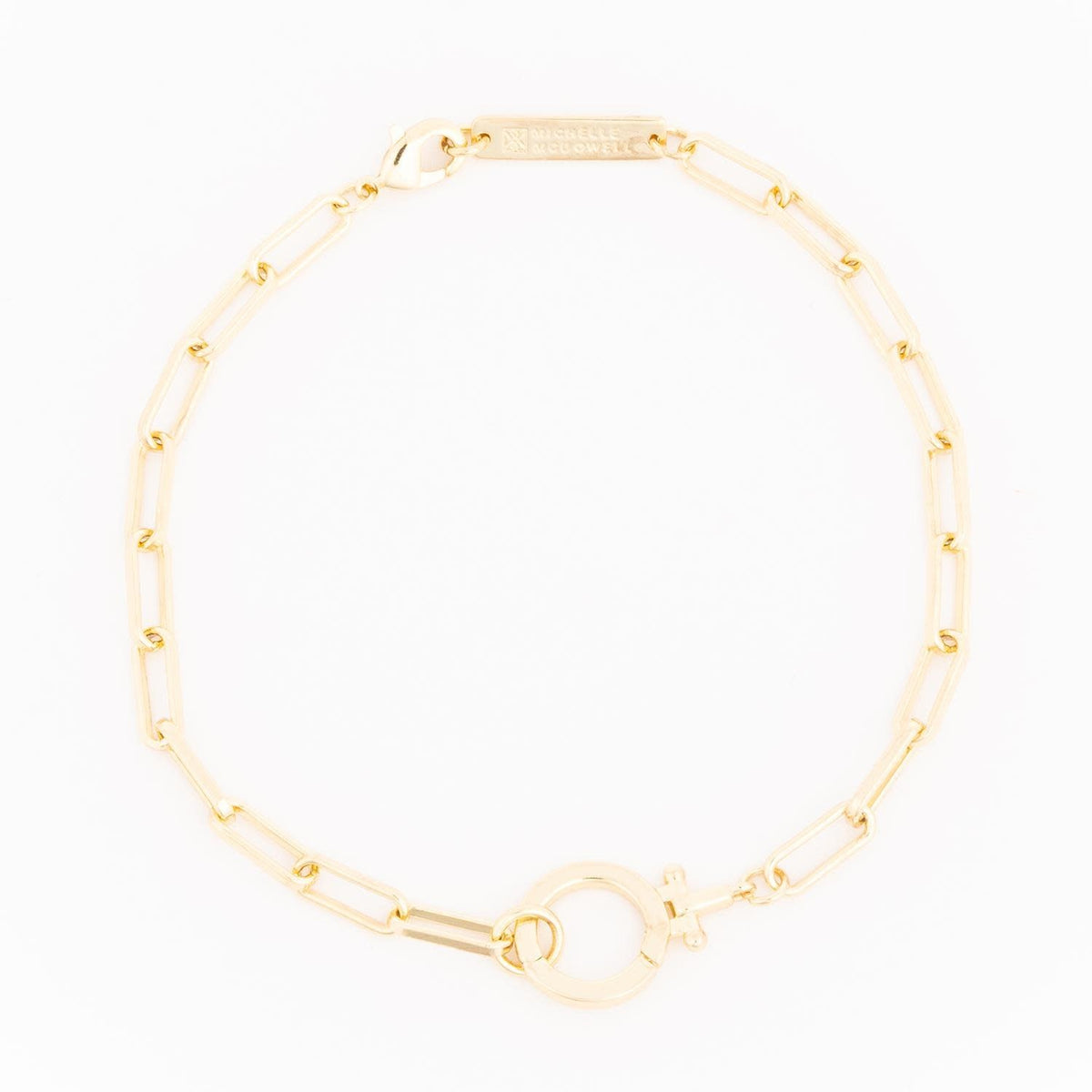 Gold Thea bracelet featuring a delicate chain link design with an elegant pendant accent.