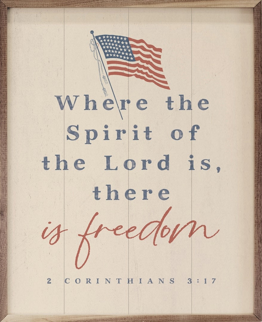 White wooden wall art featuring the text 'There Is Freedom' in a natural walnut frame.