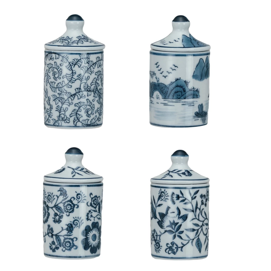 Four hand-painted blue and white stoneware spice jars with various floral and landscape patterns.