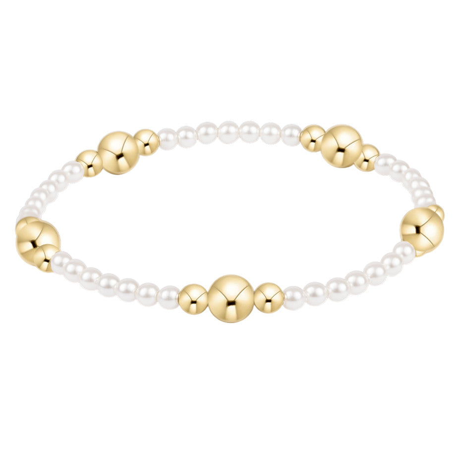 Purpose Gold 6mm Pearl Bracelet featuring white pearls and 14kt gold-filled beads on elastic.