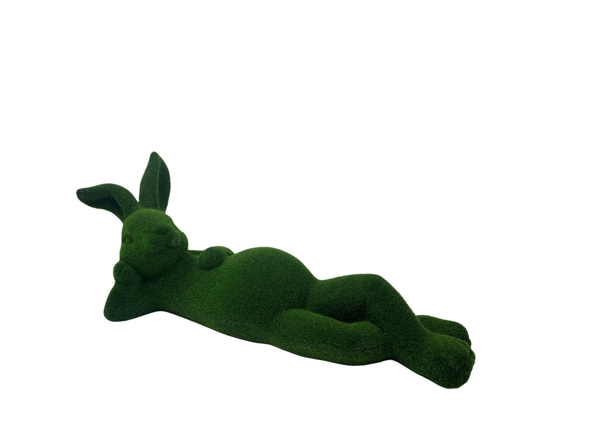 Green moss-covered bunny figurine in a relaxed laying pose against a white background.