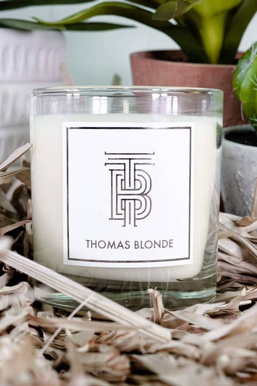 Glass jar candle with sandalwood, cedarwood, vetiver, and amber wood scents.