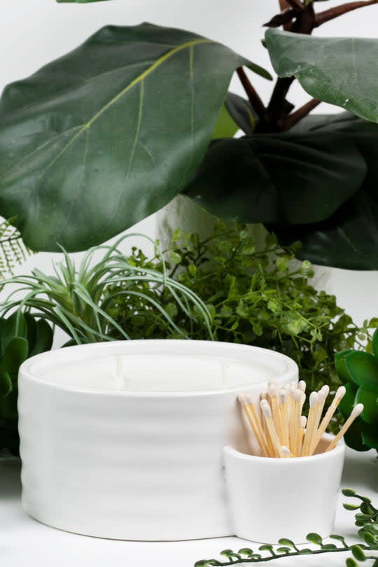 Matte white ceramic vessel candle with three wicks, included matches, and a side holder.