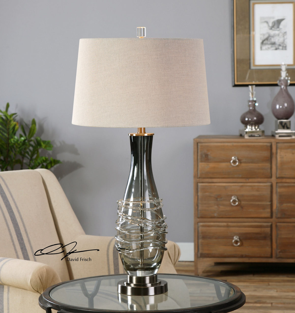 Gray glass table lamp with a cylindrical shade and simple base