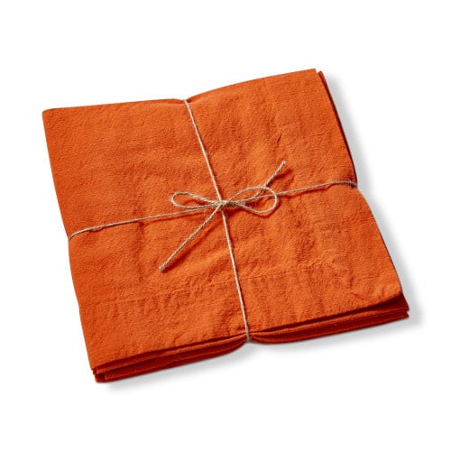 Set of orange slub napkins with a textured fabric finish.