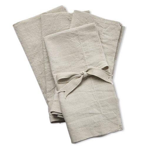 Set of sand-colored slub napkins with a textured fabric finish.
