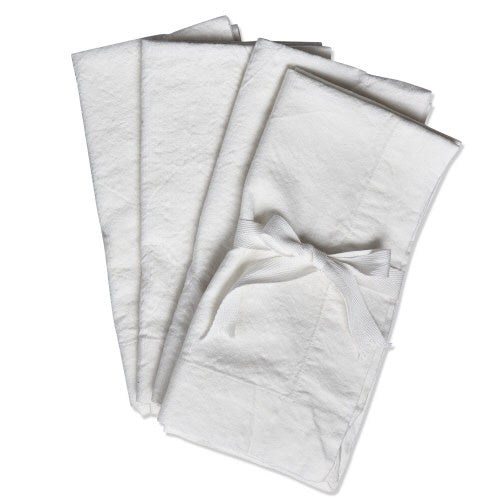 Set of white slub-textured napkins with a casual gathered edge silhouette.