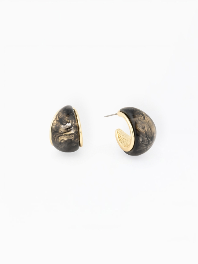 Veyda Earrings featuring black and gold marbled resin in a chunky hoop design with gold plating.