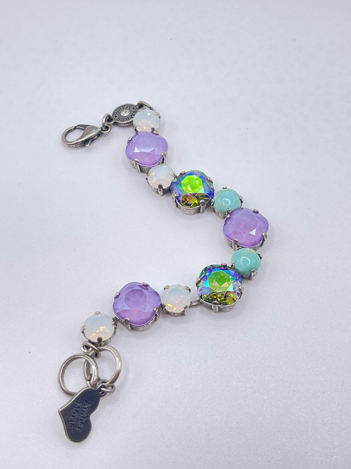 Amber Marie bracelet featuring purple, iridescent, and turquoise stones on a silver chain.