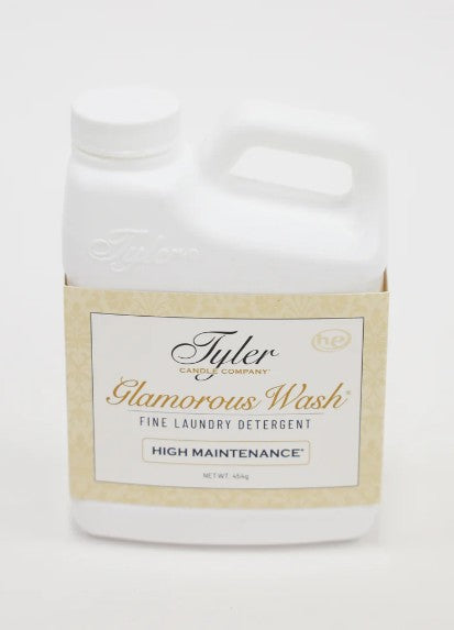 Bottle of Glamorous Wash laundry detergent in a clear container with white liquid.