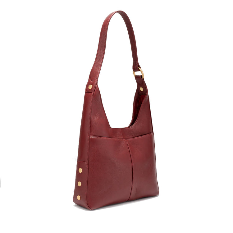Medium shoulder bag in cherrywood pebble leather with brushed gold hardware, magnetic closure, back pocket, and red lining.