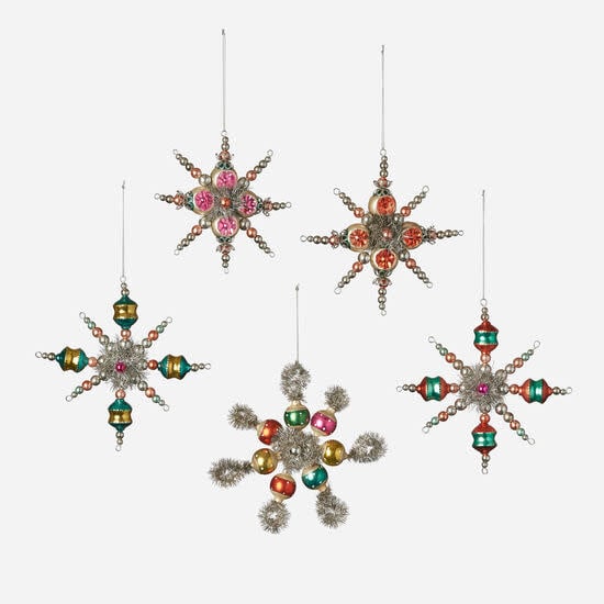 Glass starburst ornament with silver tinsel accents in a five-pointed silhouette.