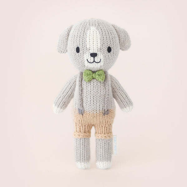 Hand-knit Tiny Noah dog doll in natural cotton yarn with a soft silhouette.
