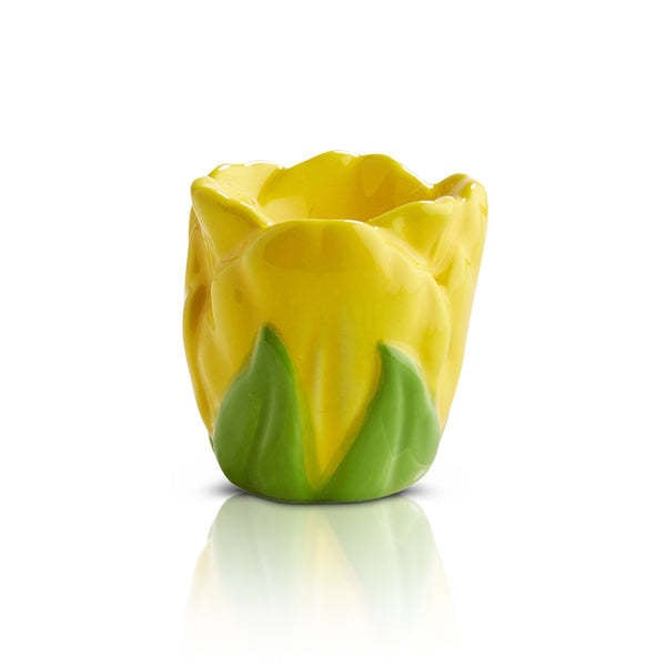 Yellow ceramic tulip-shaped egg cup with green leaf accents at the base.