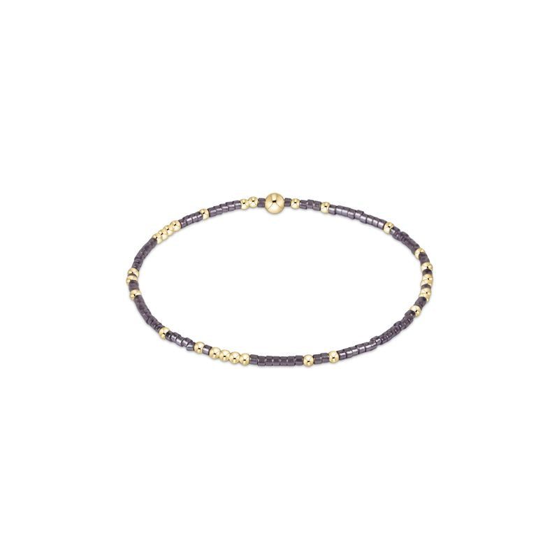 Hope Unwritten bracelet featuring mixed seed beads in various colors with gold-filled accents on elastic cord.