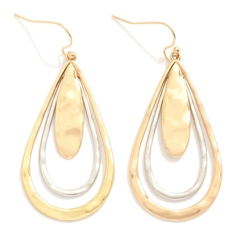 Hammered metal teardrop drop earrings with a textured finish.