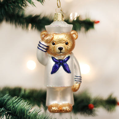 Navy blue bear ornament standing tall with a saluting paw.