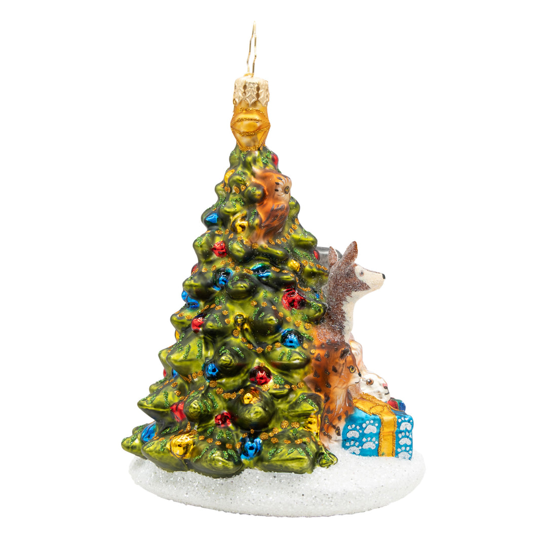 Woodland Celebration glass ornament featuring forest animals gathered around a decorated tree.