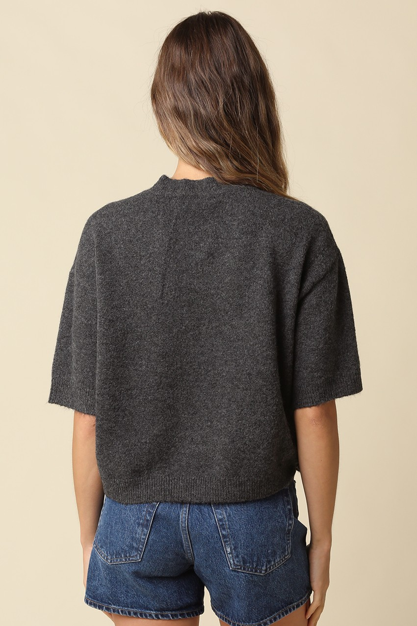 Back view of a woman wearing the Alice Parker charcoal grey half-sleeve knit sweater and denim shorts