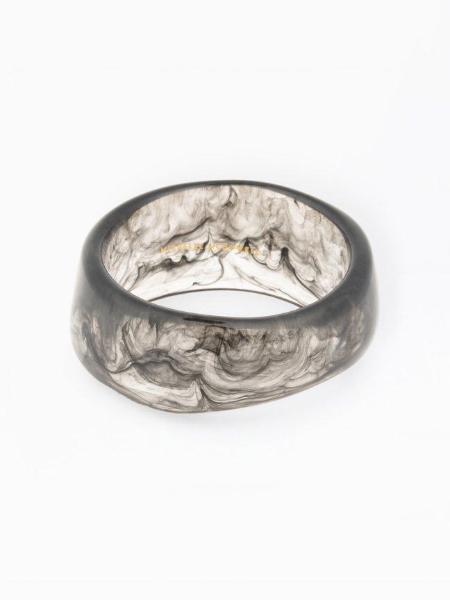 Sally Bangle, a thick resin bracelet with a translucent grey and black smoky marble pattern.