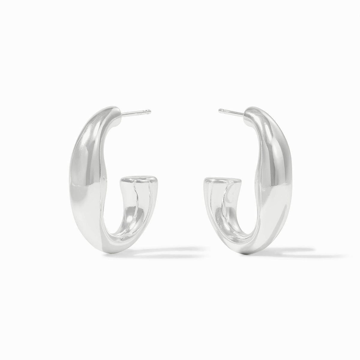 A pair of silver Laguna Hoop earrings with a thick, organic curved design and post backings.