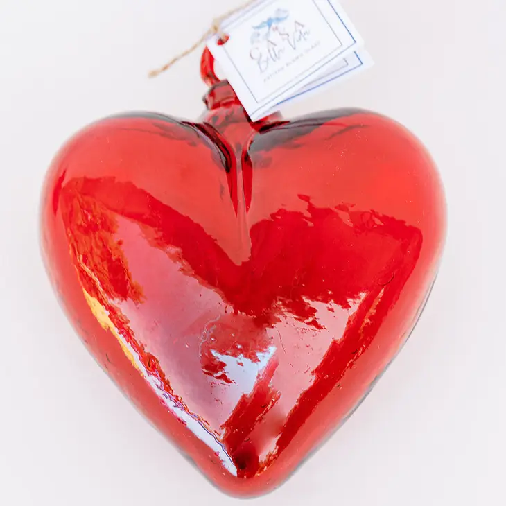Hand-blown glass heart pendant in translucent amber with smooth rounded edges.
