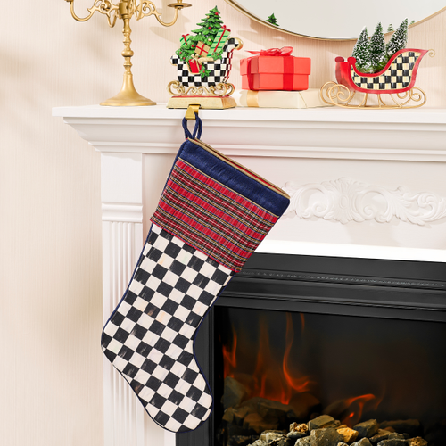 Timeless Tartan Stocking with black and white checkered pattern and red plaid cuff on a mantel.