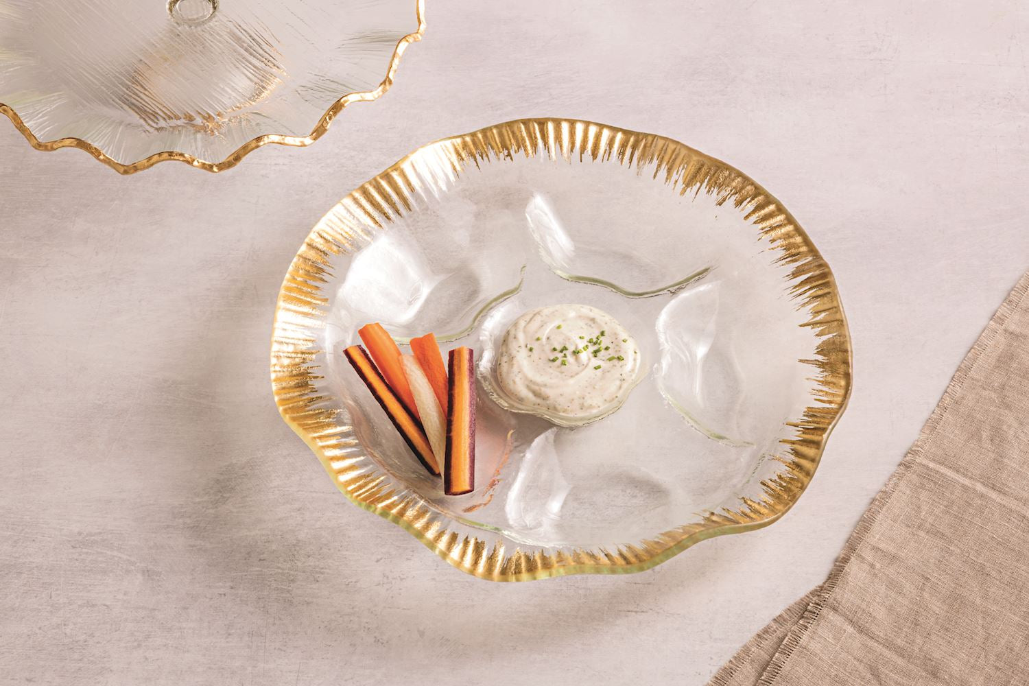 Gold Edge Ruffle Section Platter with glass dividers, holding carrot sticks and a creamy dip.