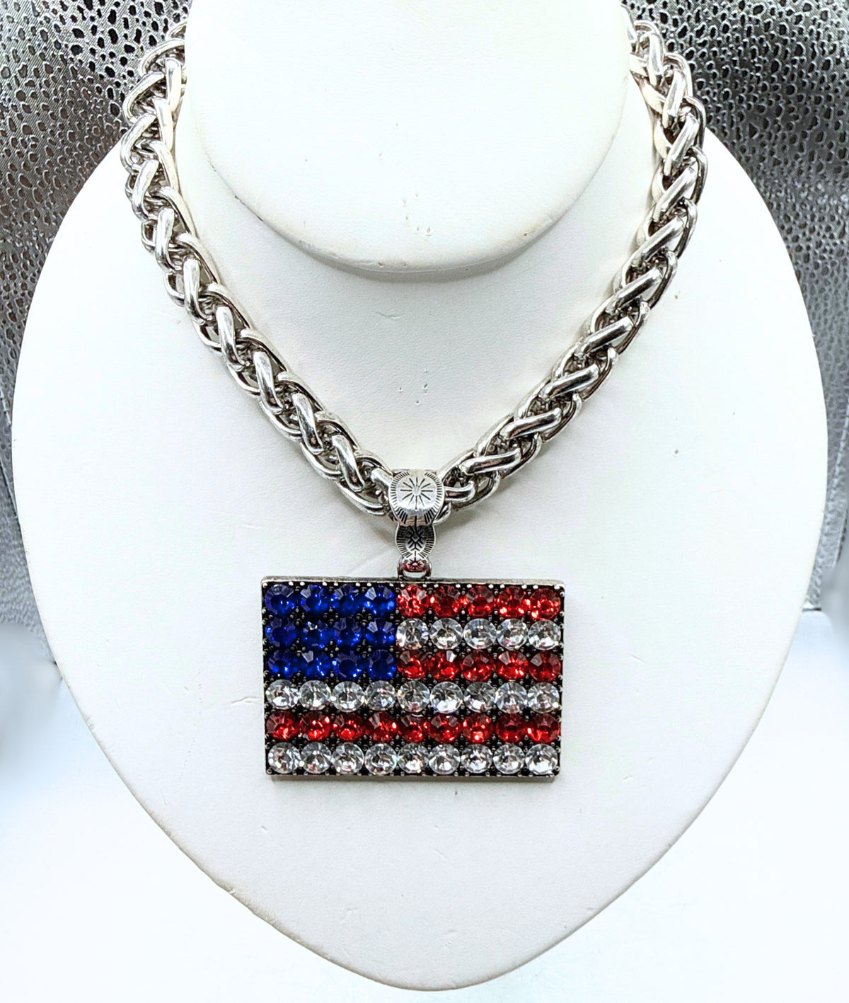 Bling silver chain necklace with a rectangular American flag pendant made of red, white, and blue.
