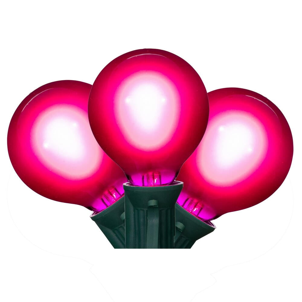 Three pink LED filament glass bulbs on a green socket wire stringer.