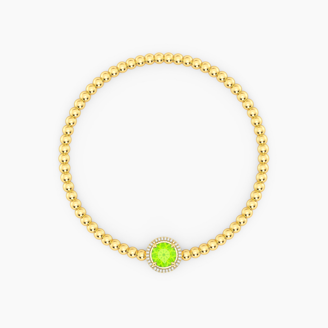 Gold beaded bracelet with a round green peridot center stone and a diamond halo.
