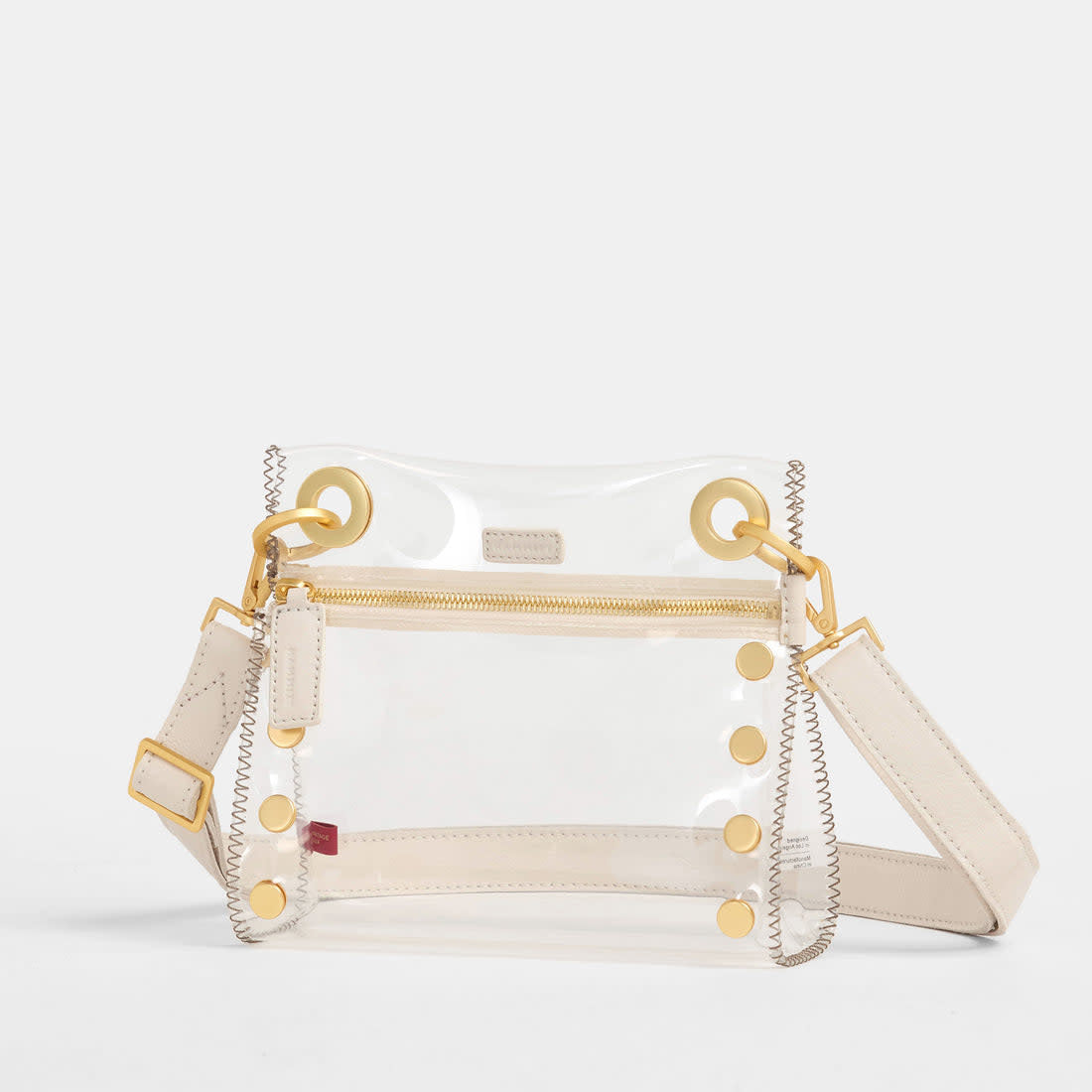 Small Tony clear bag in Calla Lily white with brushed gold leather trim and adjustable crossbody strap.