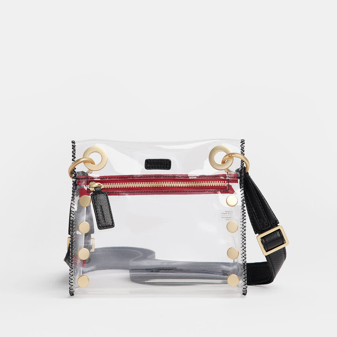 Small Tony clear bag with black brushed gold trim, red accents, adjustable strap.