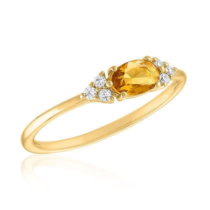 Gold layered ring featuring a central topaz gemstone with an elegant band silhouette.
