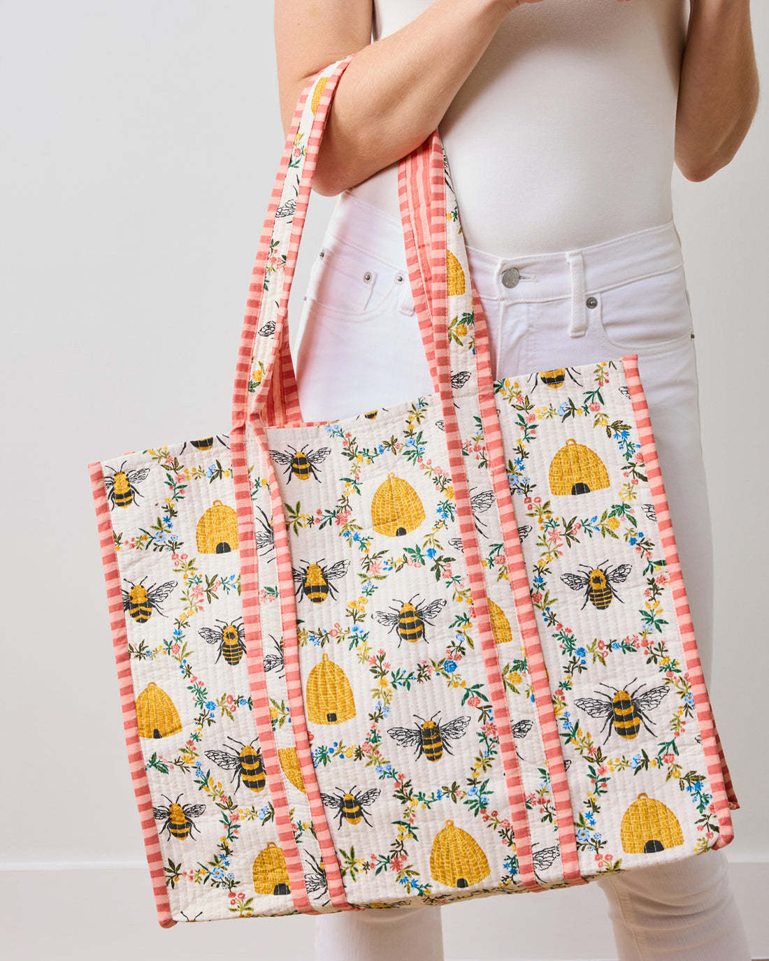 Large quilted organic cotton tote bag in Sweet Bee print with pink gingham straps and trim.