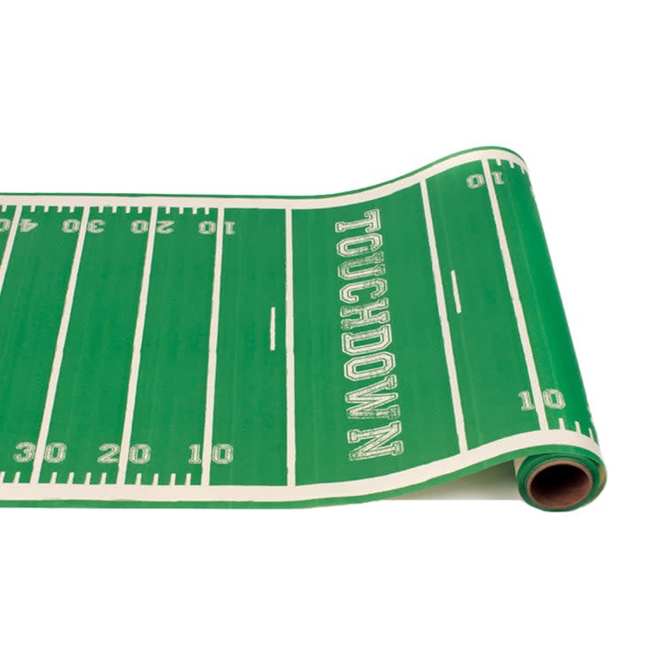 Paper table runner with football touchdown field print in green and gold.