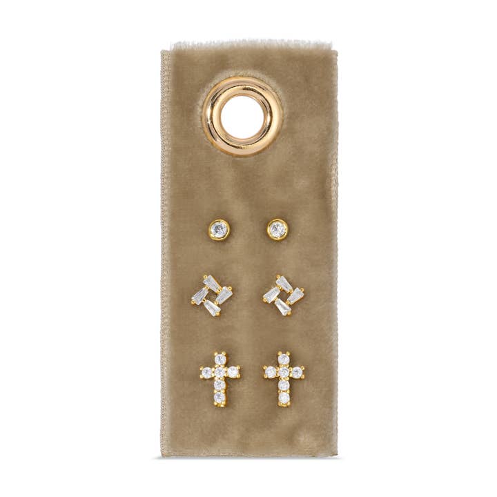 Three gold-plated stud earrings with cubic zirconia stones on a black velvet display card.