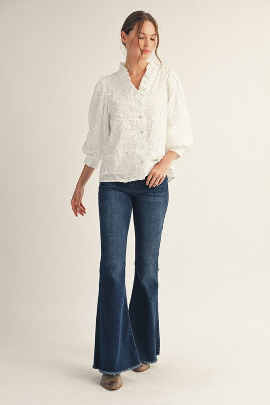 Madeline button-down top in white cotton with a three-dimensional floral pattern.