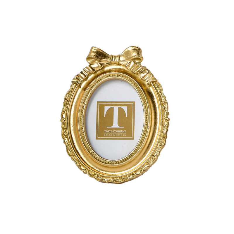 Oval gold mini photo frame with an ornate border and a decorative bow accent at the top.