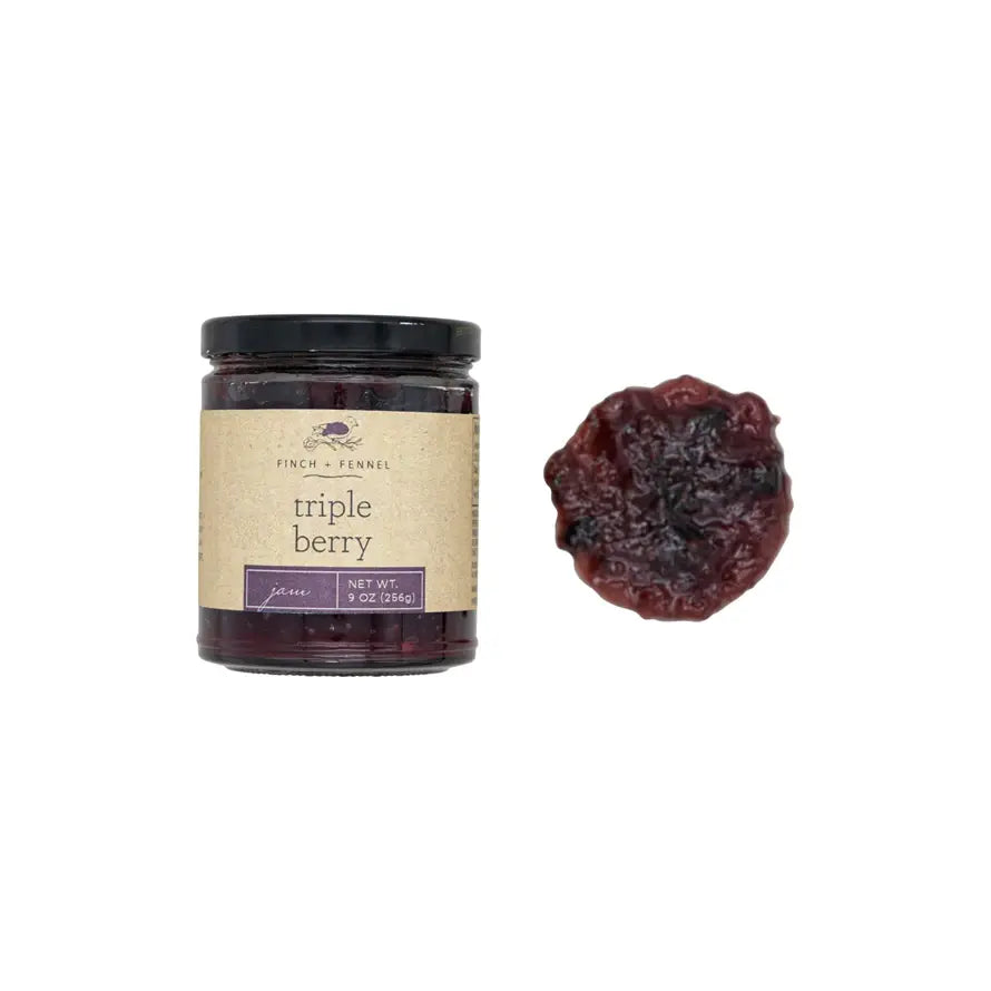 Glass jar of Triple Berry Jam with red strawberries, blueberries, and raspberries visible through clear packaging.