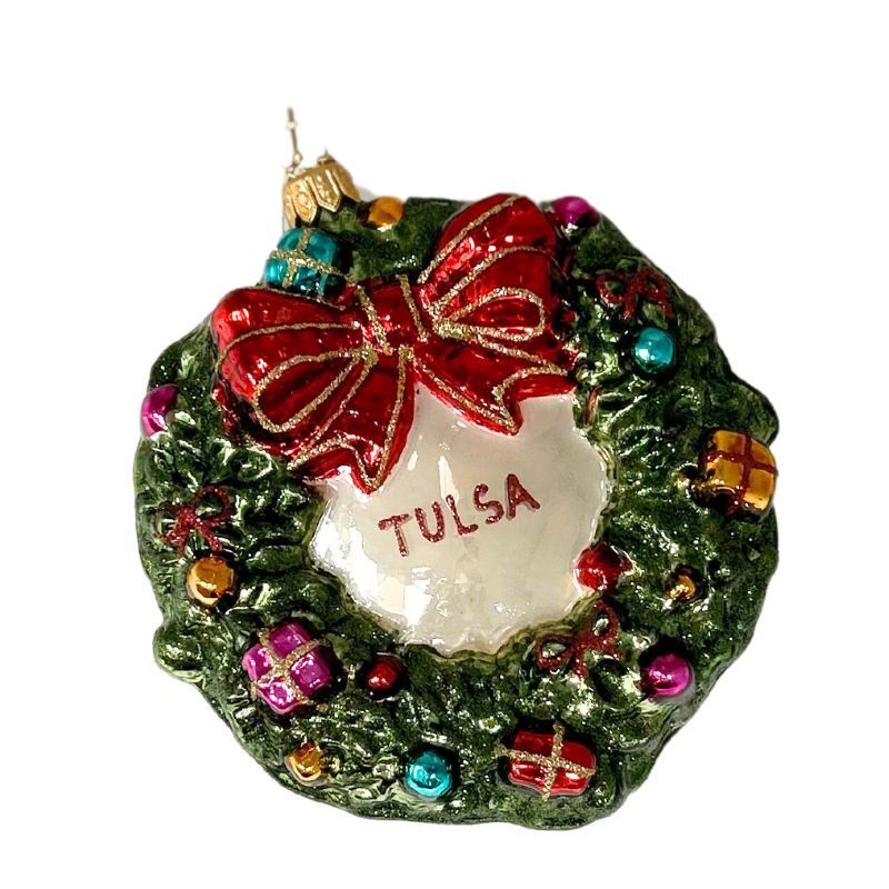 Hand-blown glass wreath ornament with a red bow, colorful presents, and "TULSA" in the center.