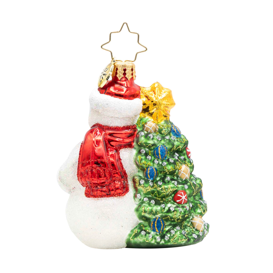 Snowy & Bright! Gem snowman ornament wearing a red scarf next to a decorated Christmas tree.