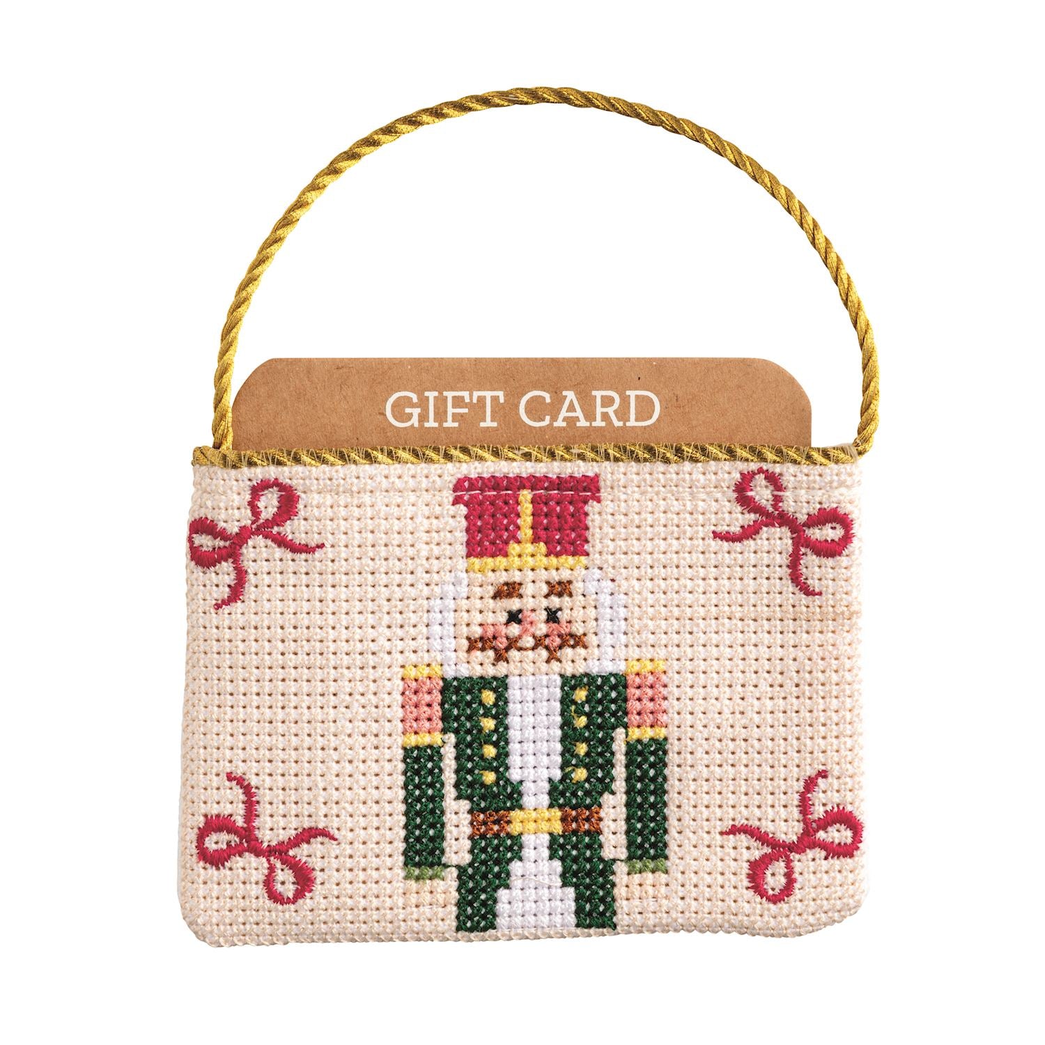 Needlepoint gift card pouch featuring a nutcracker design with a gold cord hanger.