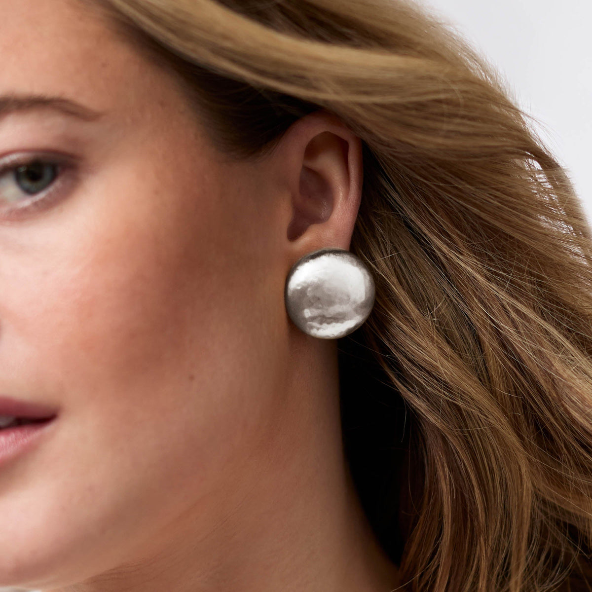 Solara Clip Silver: a one-inch pure silver plate clip-on earring with a tarnish-free finish.