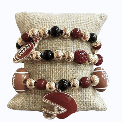 Set of three football-themed beaded stretch bracelets with gold, black, and maroon beads and charms.