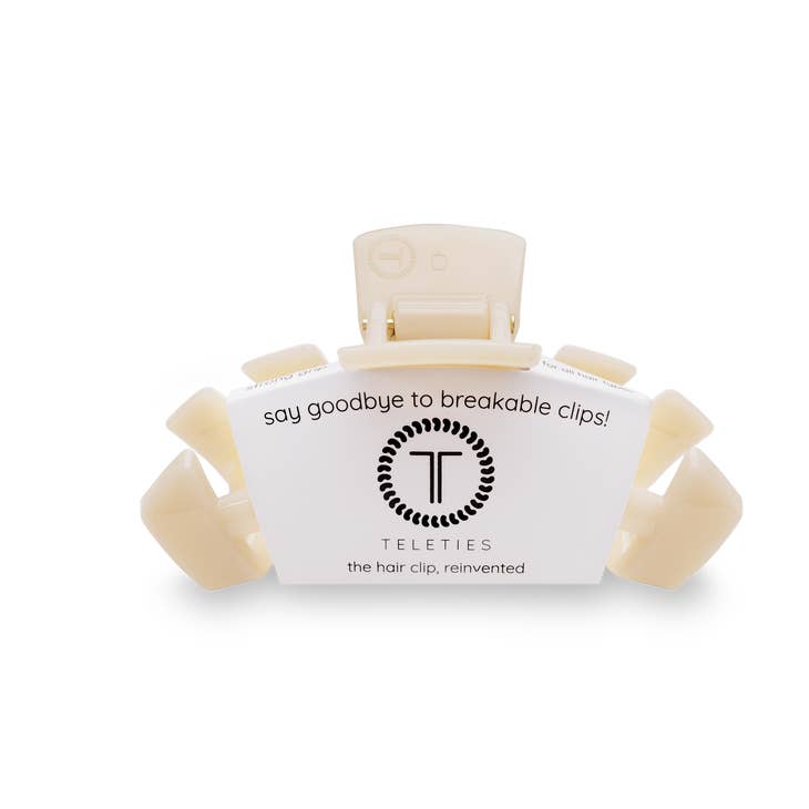 Medium hair clip with bendable teeth in a neutral tone designed to hold thick to medium-thickness hair.
